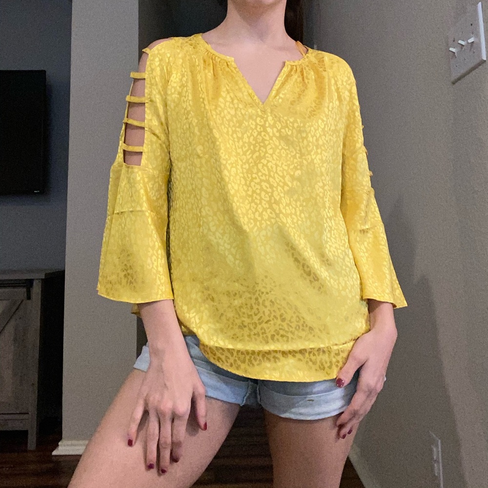 Jennifer Lopez cold shoulder gold leopard blouse